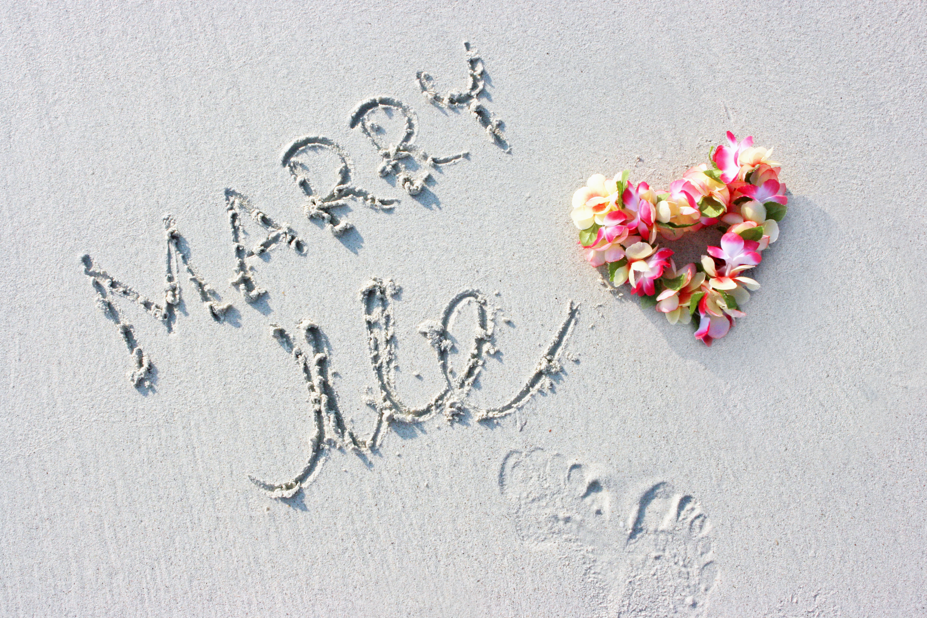 Hawaii flowers and marriage proposal sign on the beach